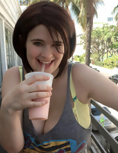 Big-tittied girl takes pictures on the beach and in the cafe