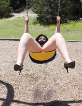 Mature woman rides on a swing with no panties in hot porn pics