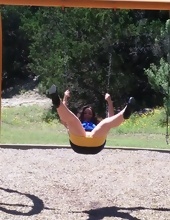 Mature woman rides on a swing with no panties in hot porn pics