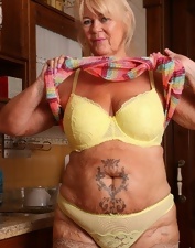 Granny is having mature porn photo session in kitchen and showing mature cunt