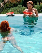 Juicy lesbian duo showing off by the swimming pool